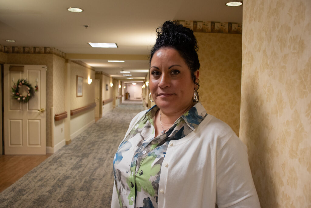 Angela Ramos stands in one of the Personal Care hallways at St. John's Herr Estate.